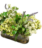 Arreglo Floral de Hydrangeas en Tonos Verdes y Follajes Artificiales en Base de Vidrio Rectangular con Agua Acrílica