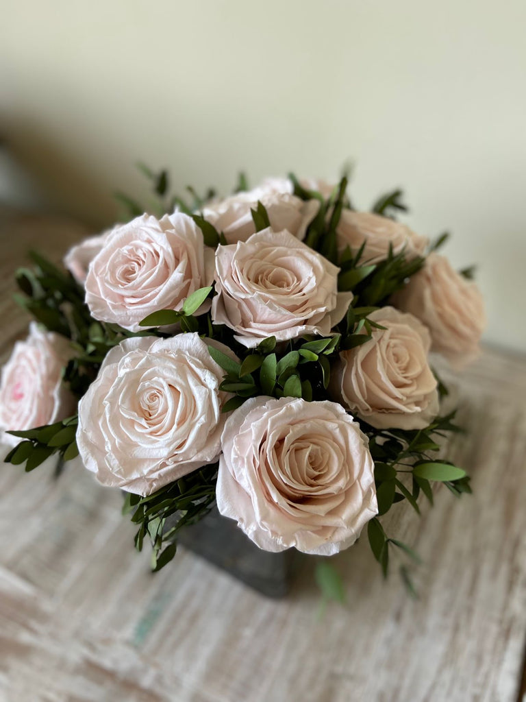 Arreglo Floral con Doce Rosas Preservadas Color Rosa Claro en Base Cuadrada de Vidrio con Agua Acrílica
