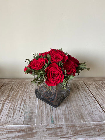 Arreglo Floral con Doce Rosas Preservadas Color Rojo en Base Cuadrada de Vidrio con Agua Acrílica