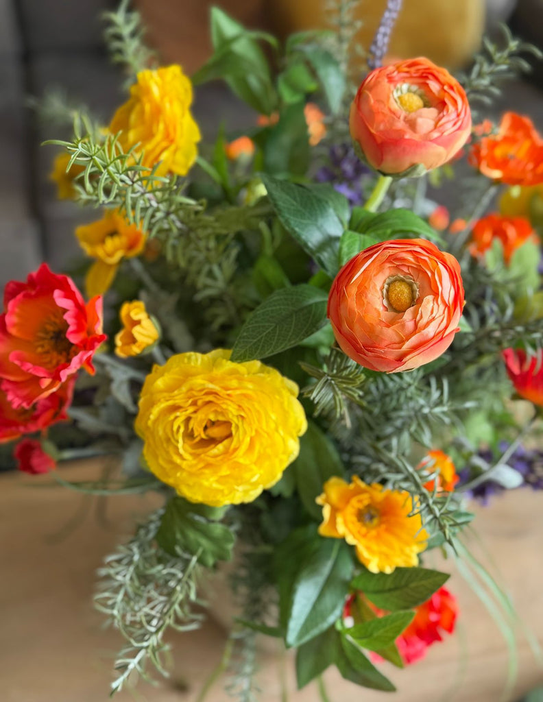 Arreglo Floral con Ranunculus y Follajes Artificiales en Base Cantera
