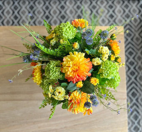 Centro de Mesa Artificial con Dahlias en Tonos Naranjas Base Cristal Espejo.